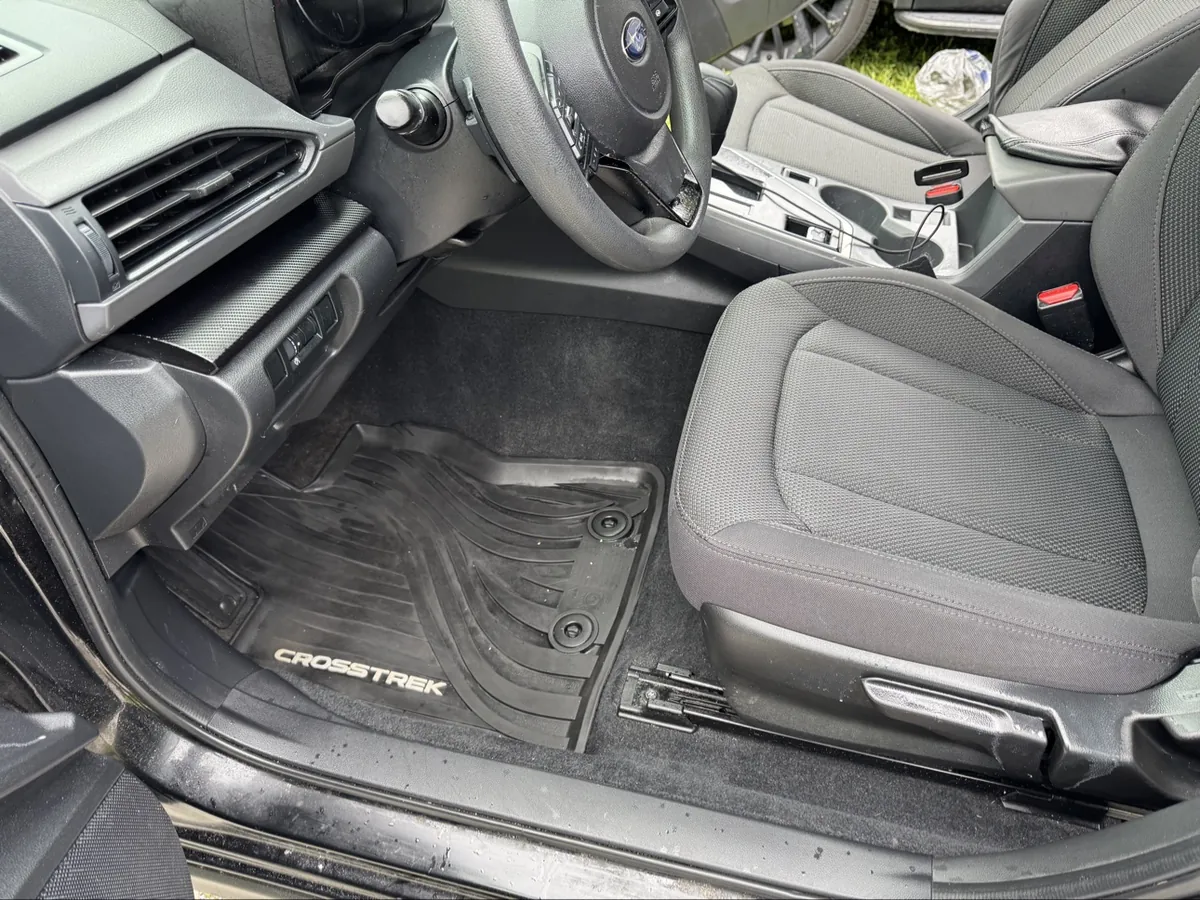Finished Subaru Crosstrek driver footwell after detailing — clean floor mat and seat
