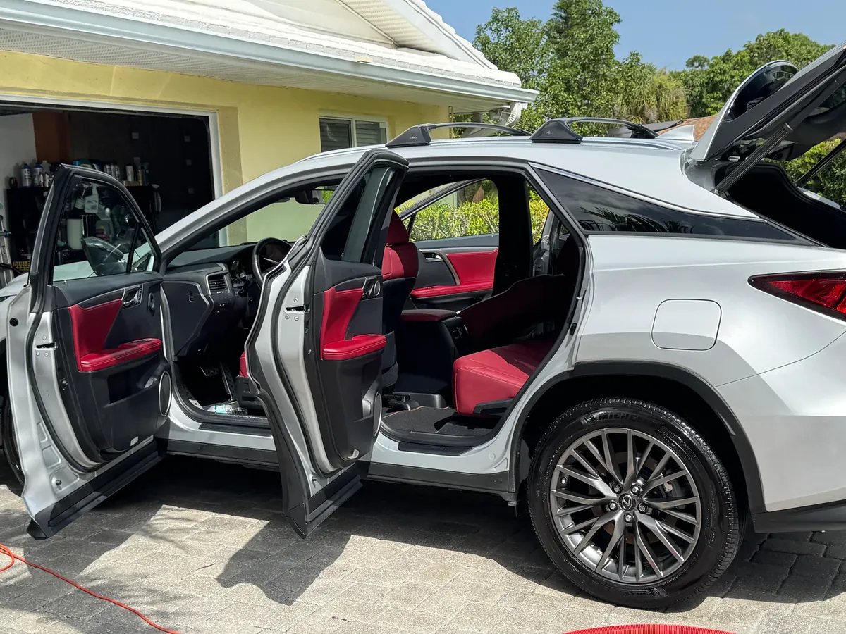 Finished white SUV with clean red and black interior, detailed at home