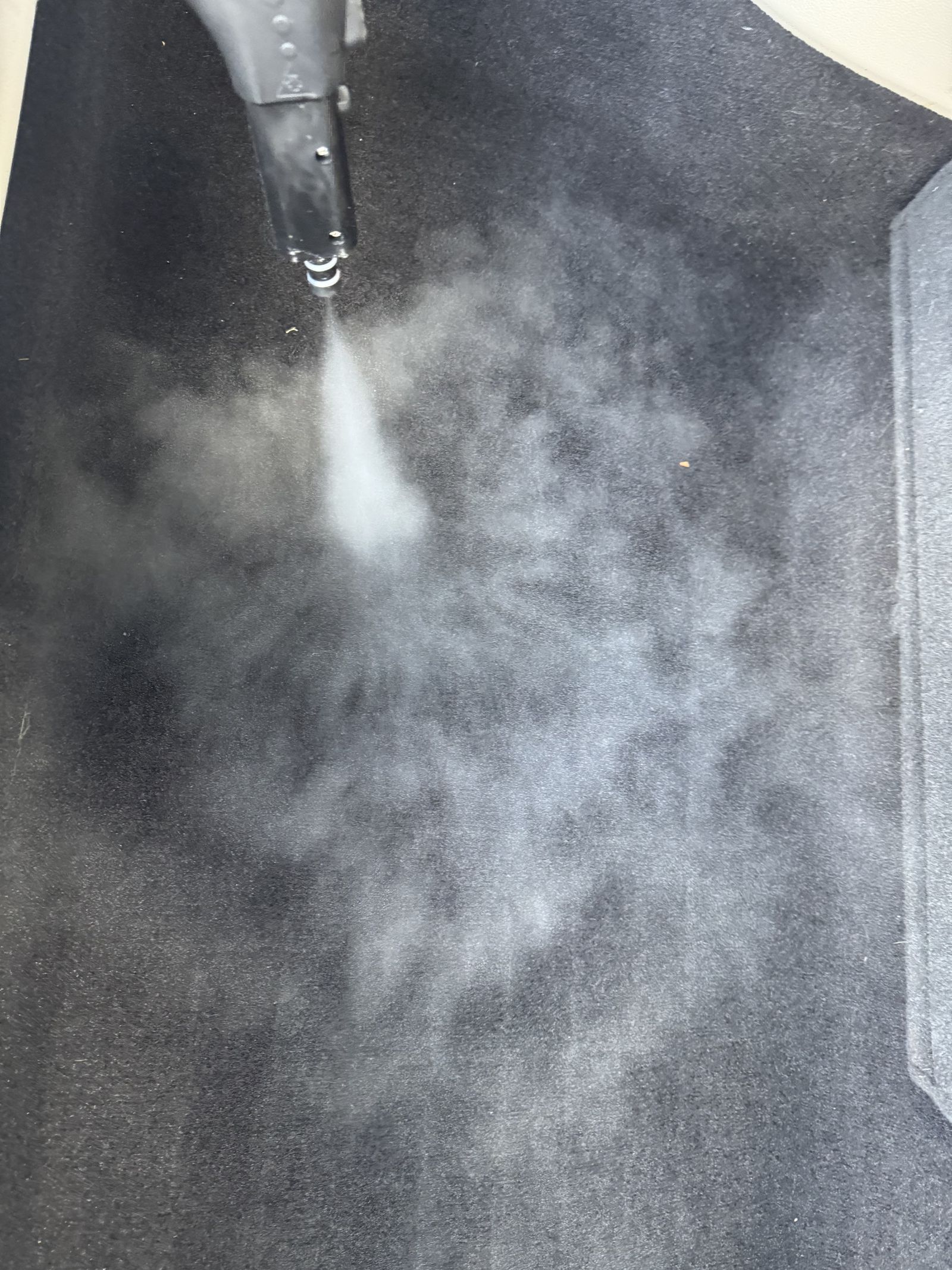 Steam extraction tool cleaning carpet mid-detail