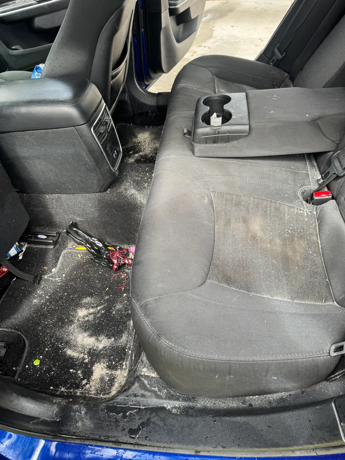 Rear seat and carpet before detailing — sand, crumbs and ground-in dirt